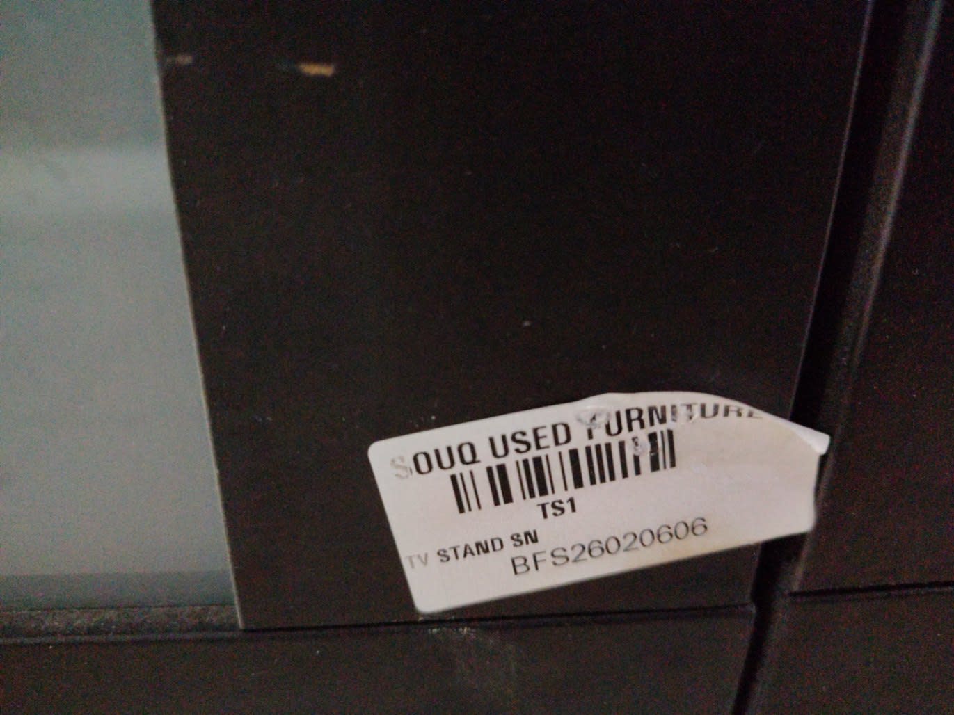 Bufaisal barcode label BFS26020606 for used TV stand at Shop C Ajman