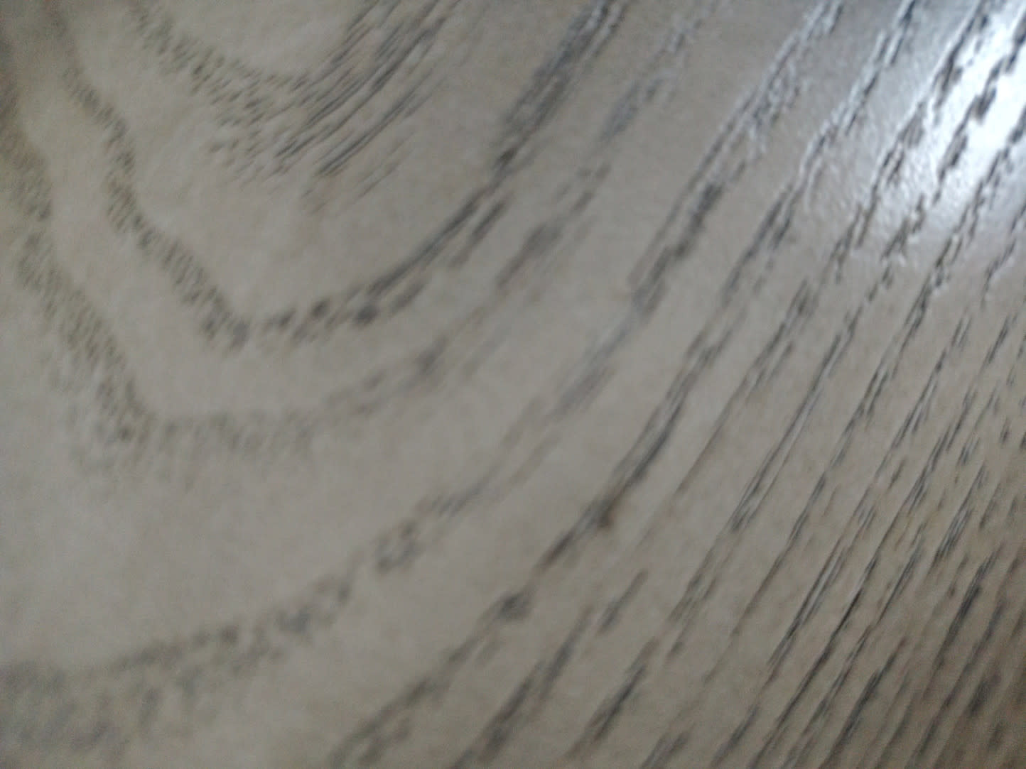 Close-up of white oak wood-grain surface texture on used TV stand at Bufaisal Ajman