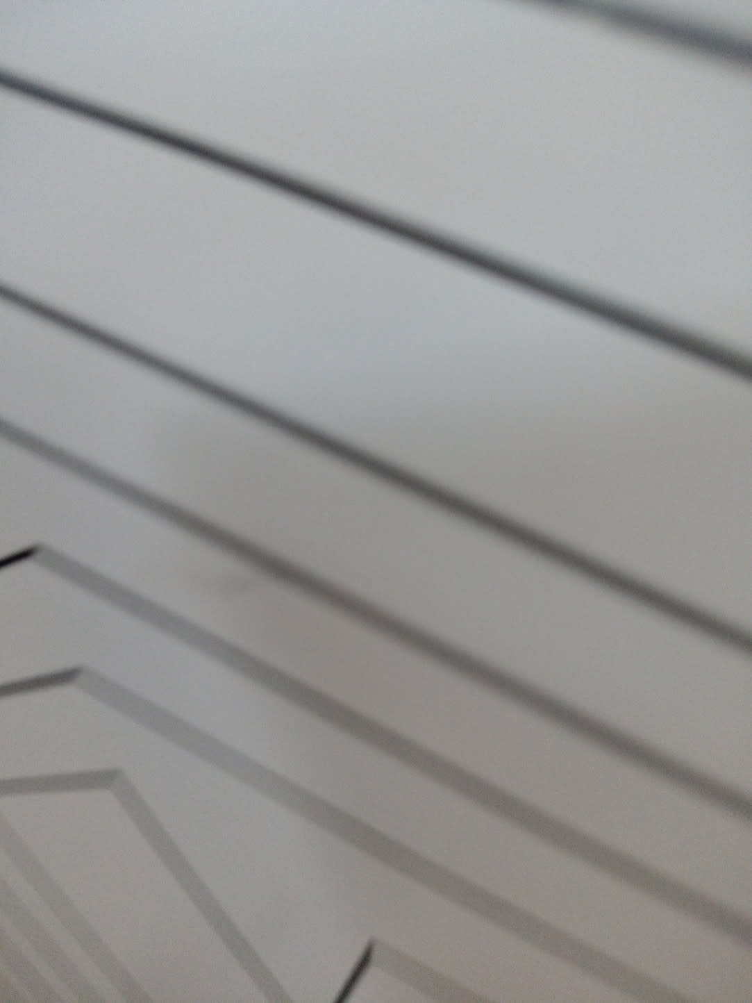 Close-up of geometric pattern on drawer fronts of used white dresser at Bufaisal Ajman