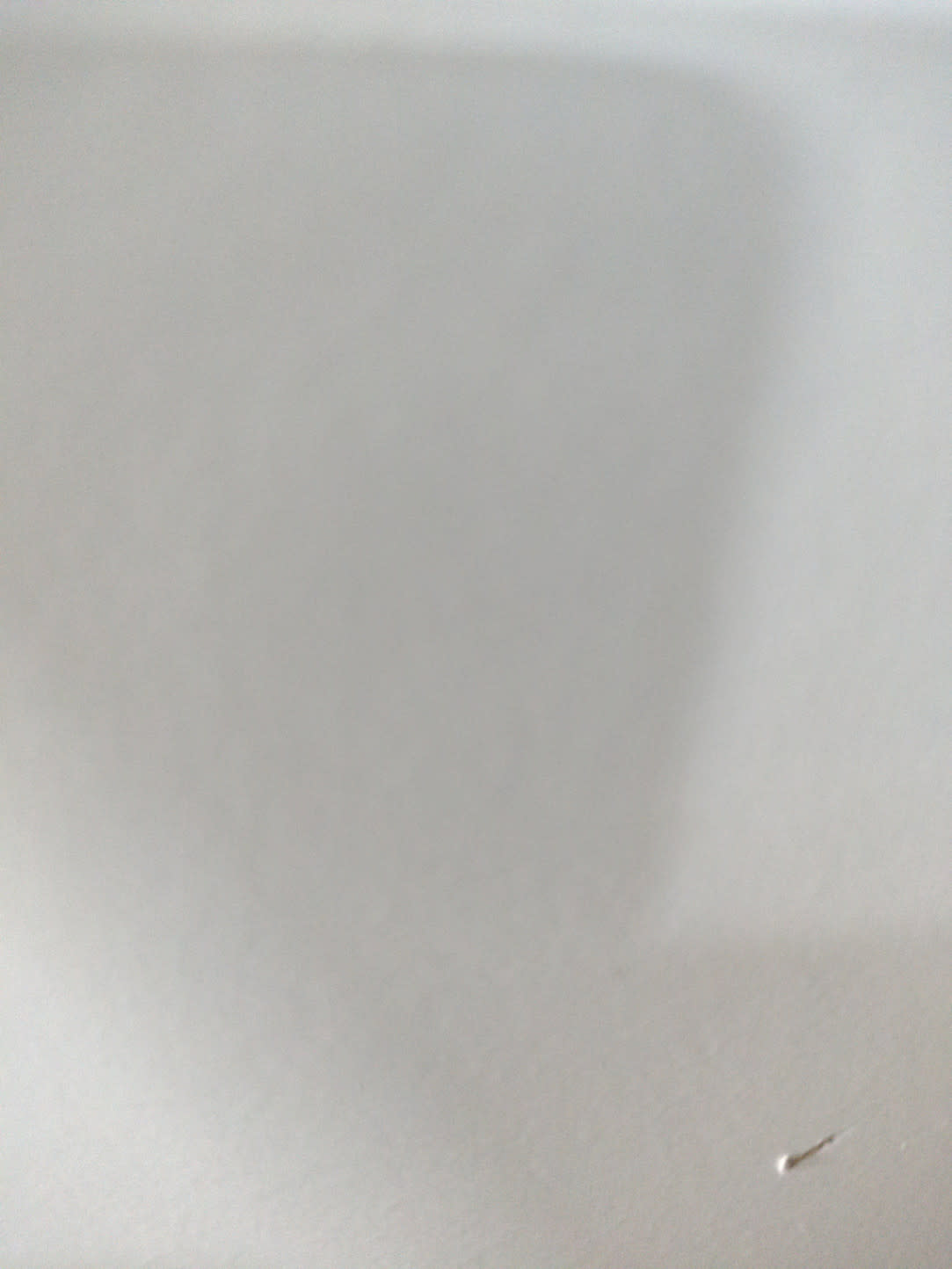 Close-up of white wardrobe panel surface — barcode label not visible in this photo