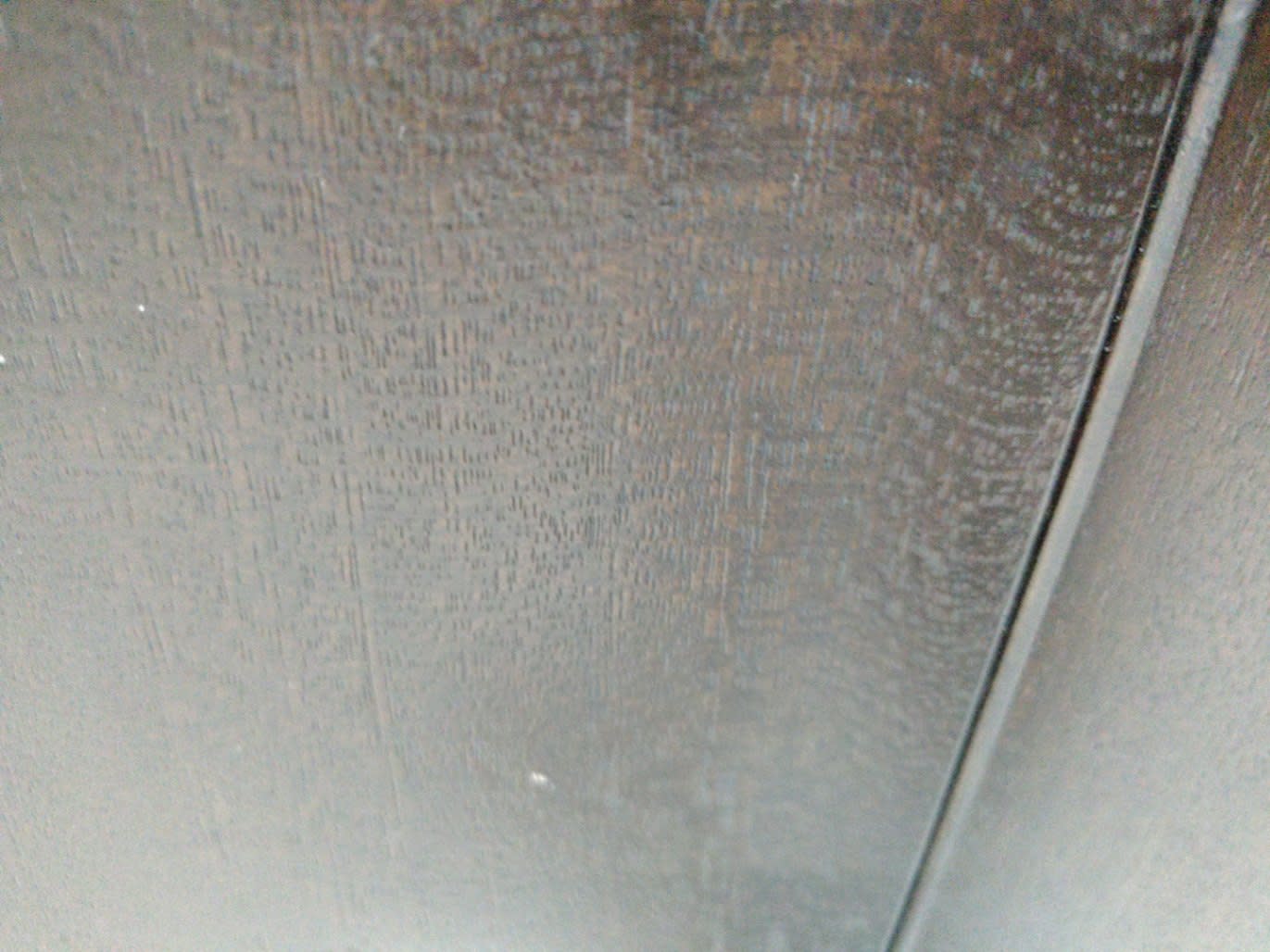 Close-up of dark brown sideboard cabinet surface showing minor scratches and wear