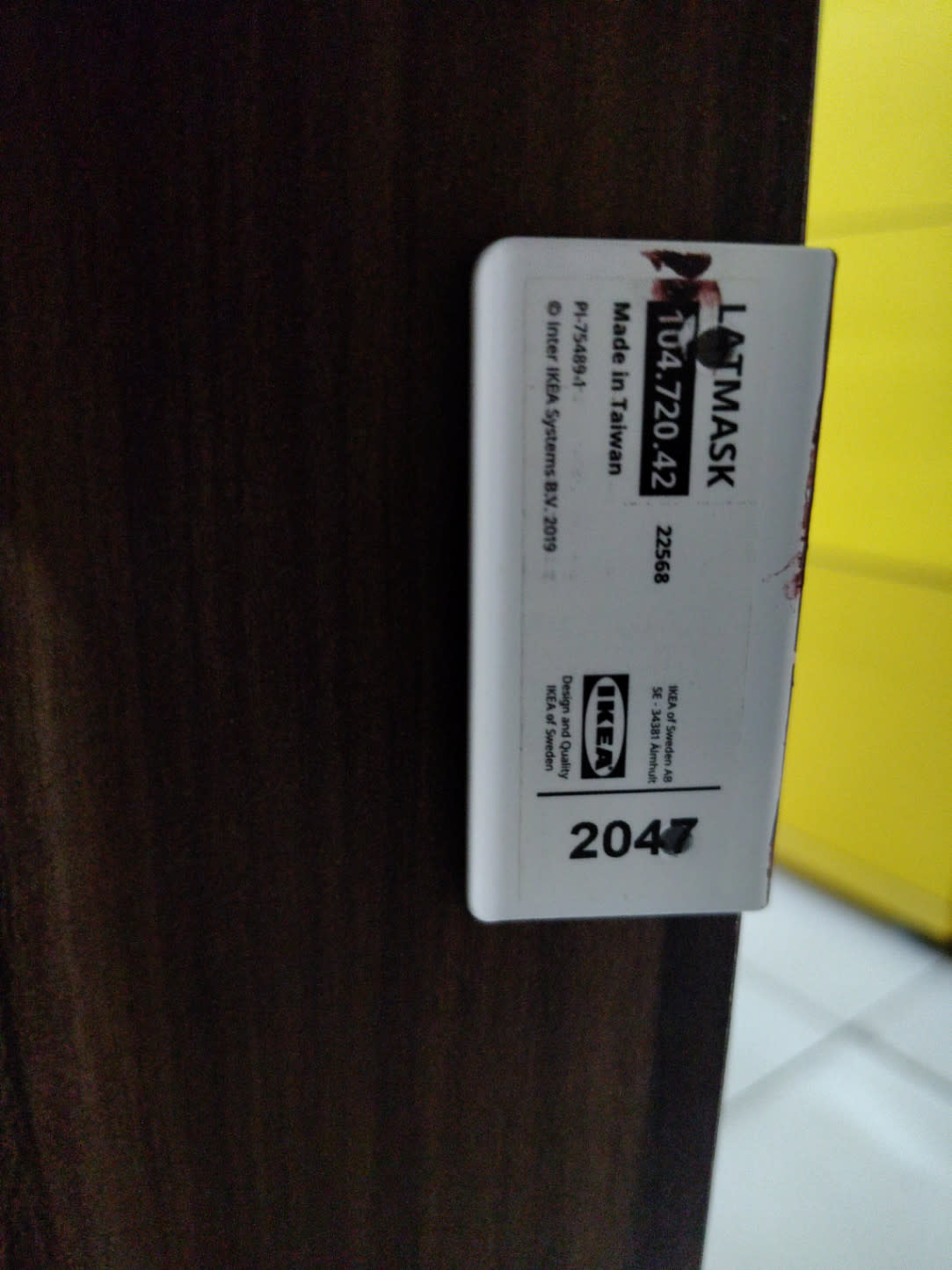 Close-up of used IKEA LATMASK desk surface and lower cabinet showing minor scuffs in good condition
