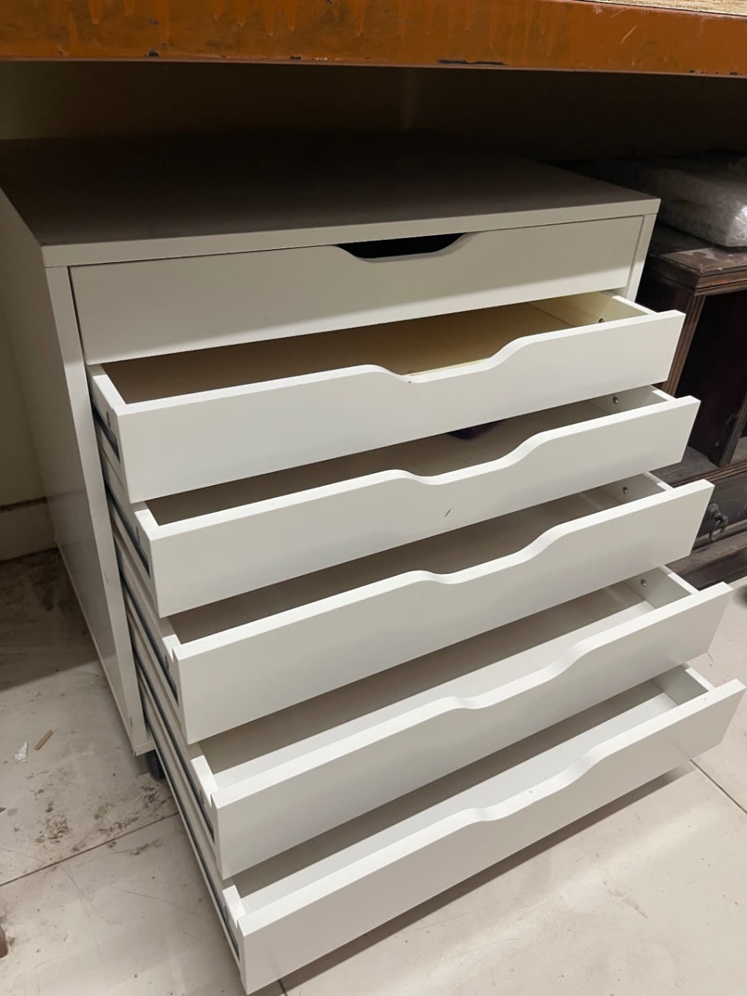 Angled open-drawer view of used white 6-drawer rolling storage cabinet at Bufaisal Ajman