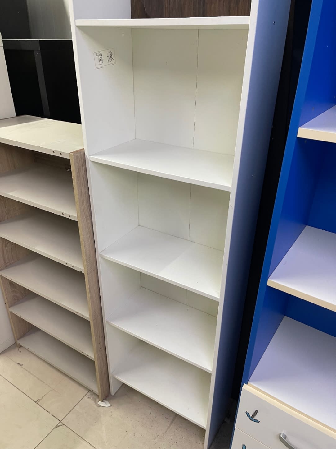 Barcode label area on used white 4-shelf bookcase at Bufaisal Ajman