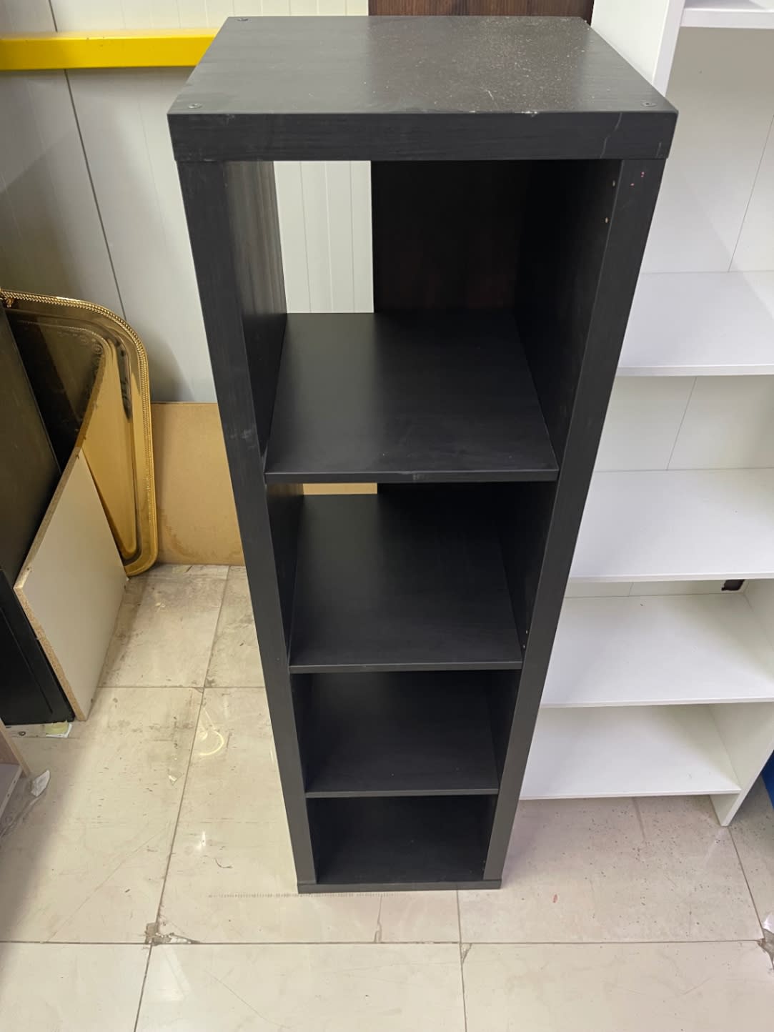 Top-angle view of used 4-shelf dark brown bookcase showing top panel condition at Bufaisal Ajman