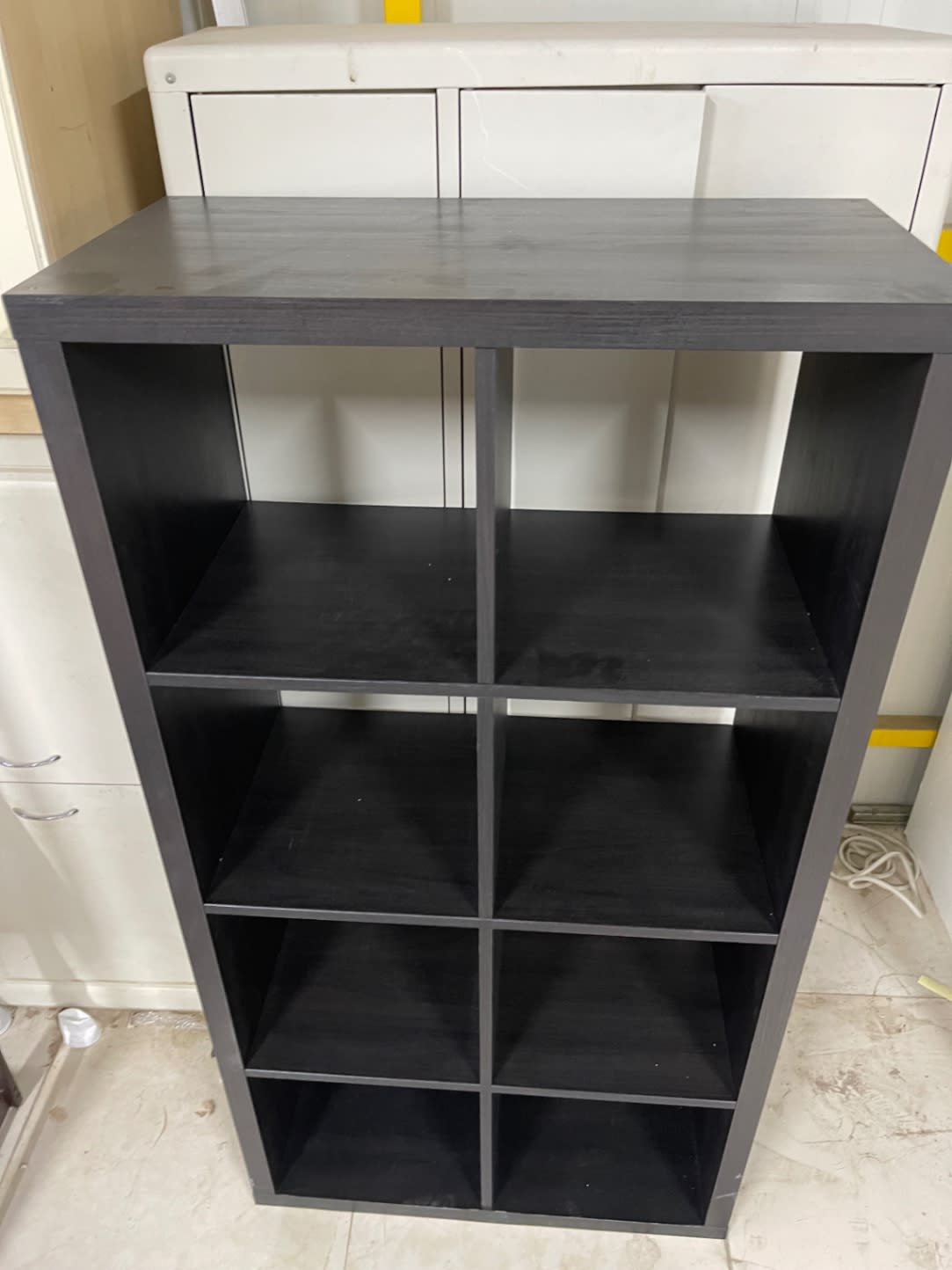 Top-down front view of used 8-cube storage shelf black-brown at Bufaisal Ajman