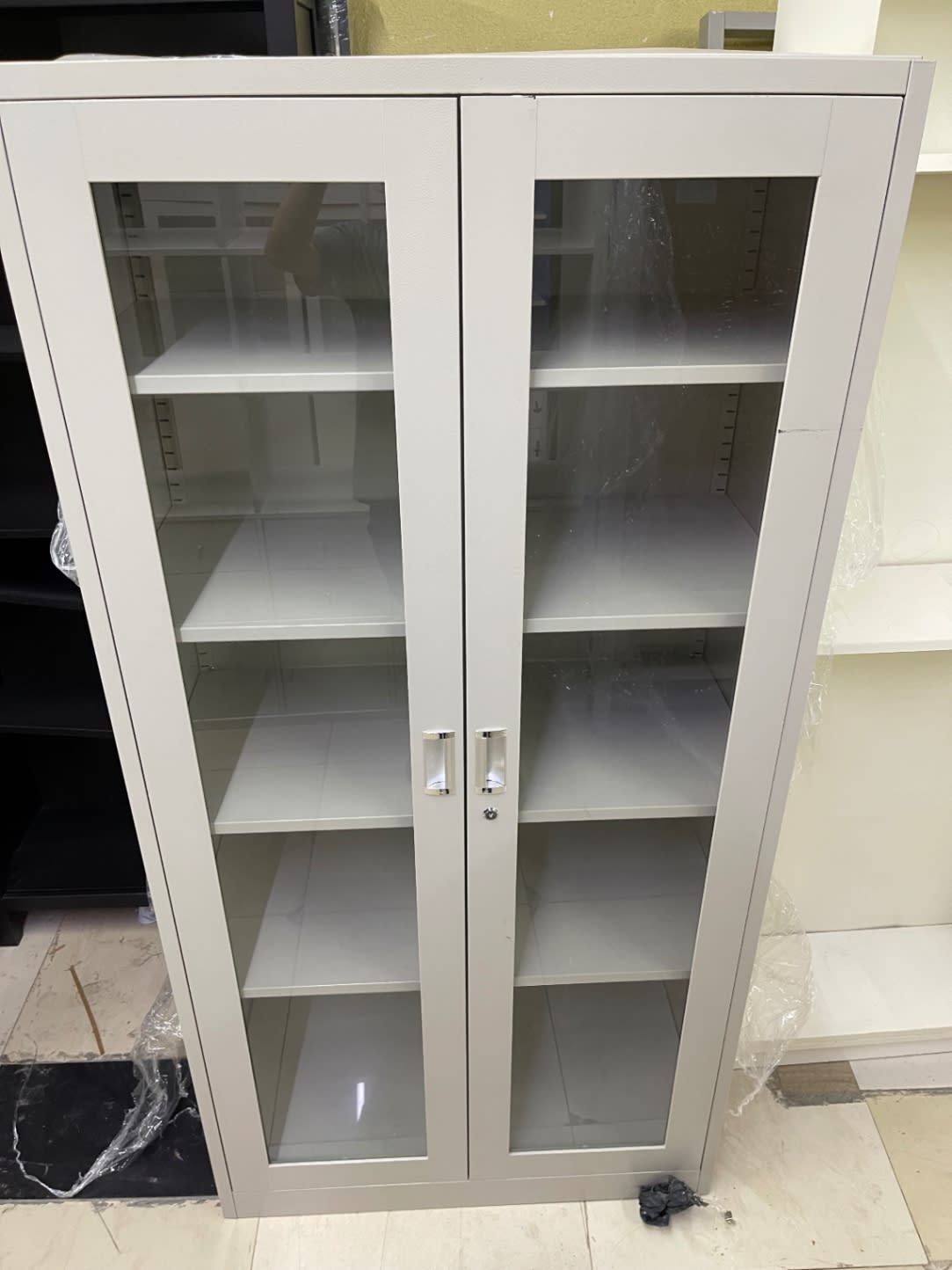 Bufaisal barcode label for used glass-door metal storage cabinet at Shop C Ajman