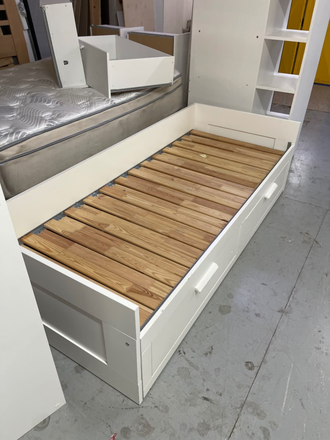 End view of used white single bed frame with storage drawers at Bufaisal Shop C