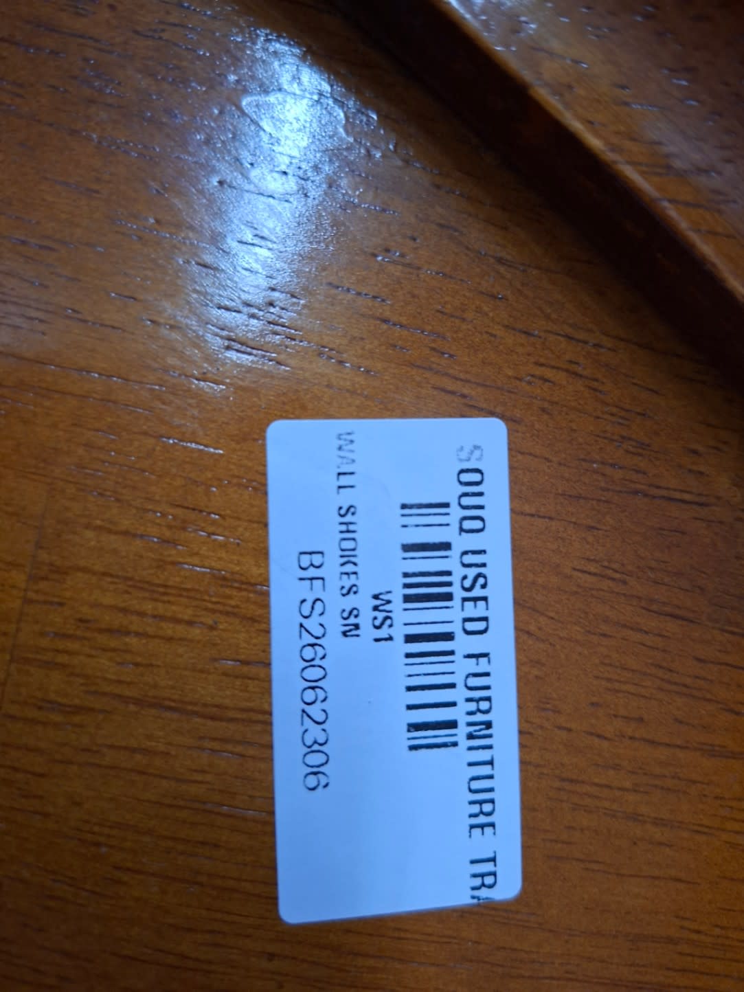 Bufaisal barcode label BFS26062306 for used wooden display cabinet at Shop C Ajman