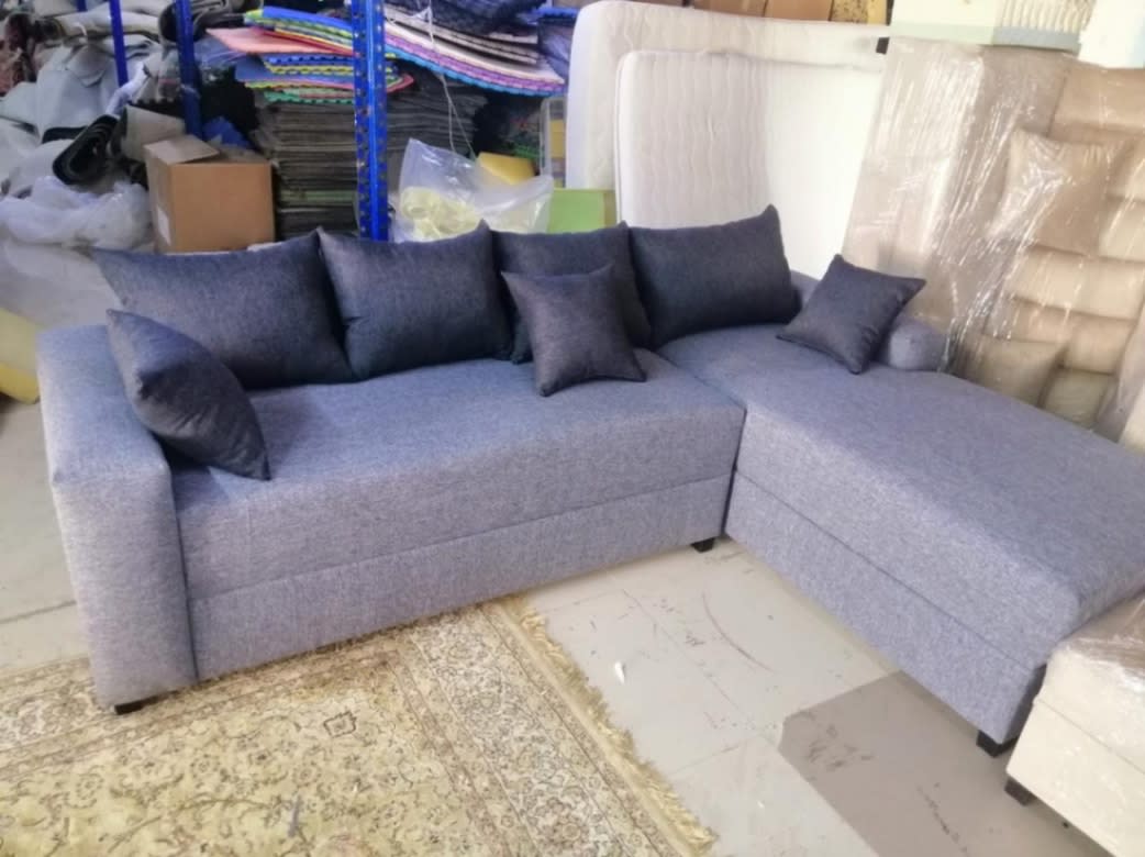 New L-shape sectional sofa in light grey fabric with chaise and cushions, Bufaisal Ajman