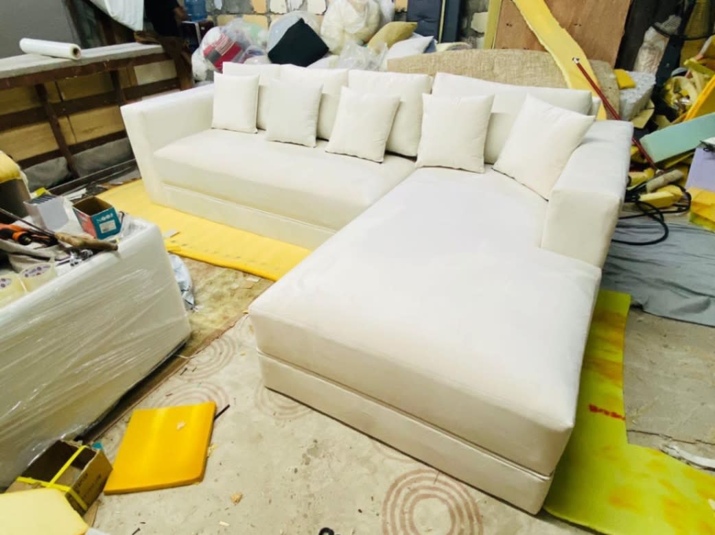 New off-white L-shape sectional sofa with chaise made to order at Bufaisal factory Ajman