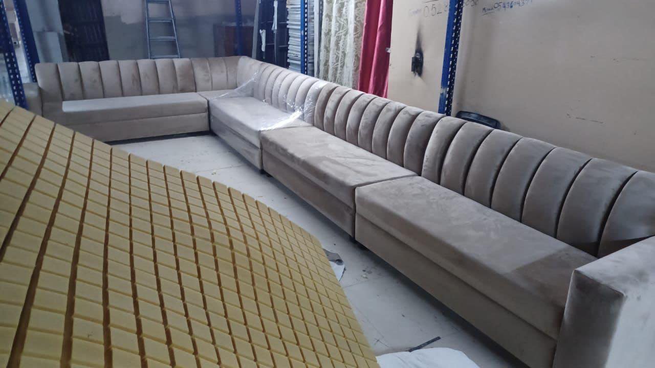 New beige channel-tufted U-shape sectional sofa fresh from Bufaisal factory, Ajman