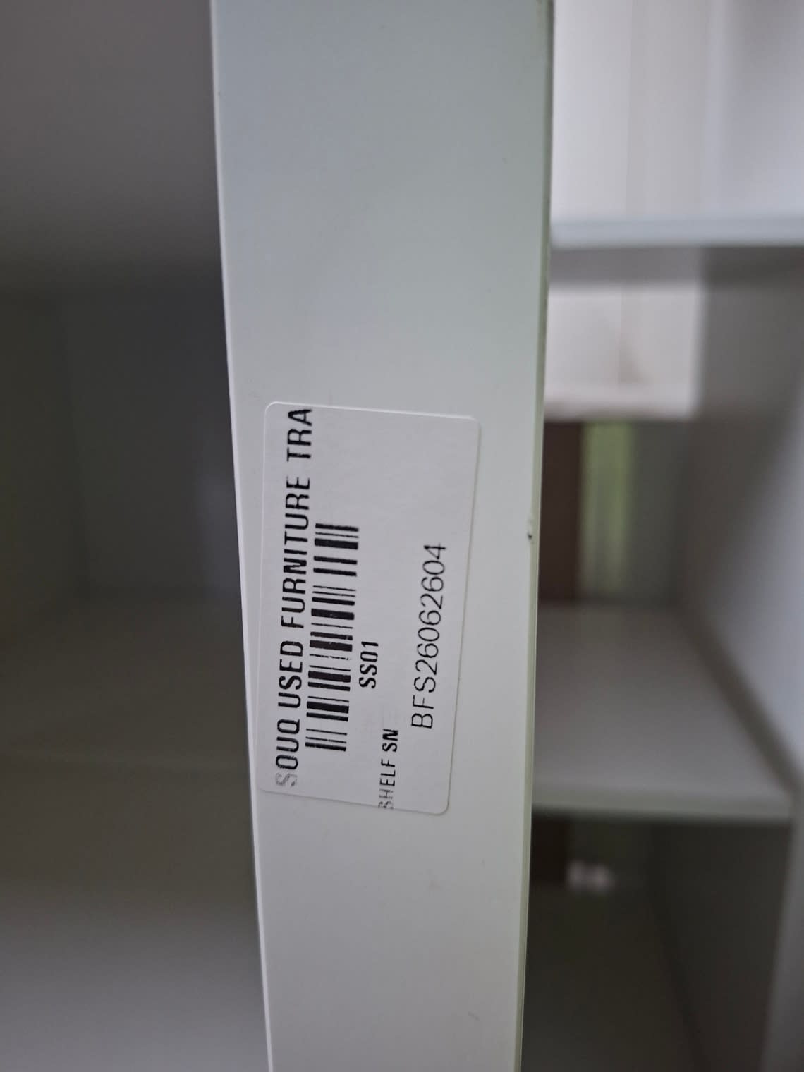 Bufaisal barcode label BFS26062604 on used white 16-cube shelving unit