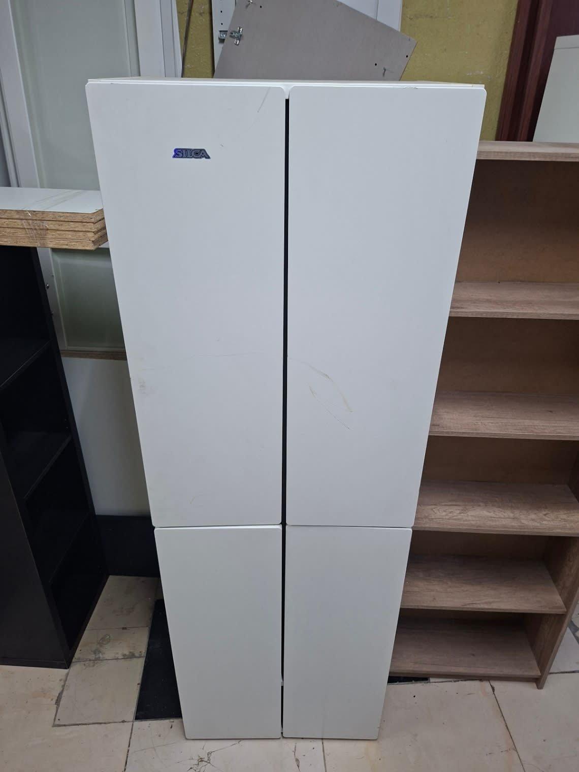 Second front view of used SILCA 4-door white wardrobe showing surface scratches on door panels