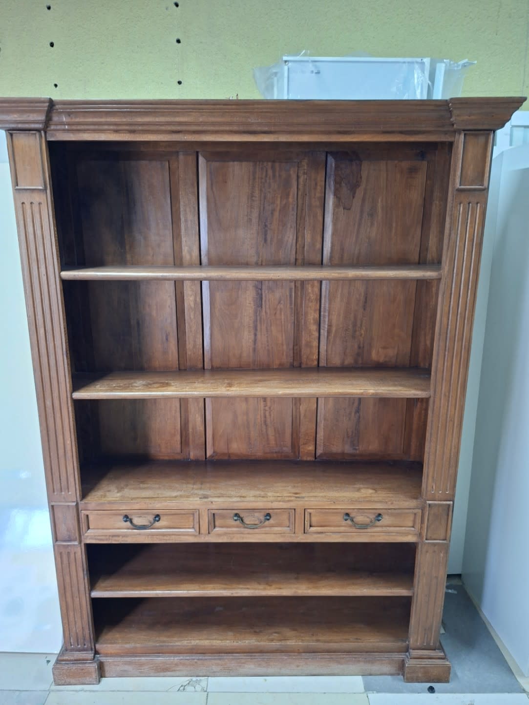 Full front view of used solid wood bookshelf with drawers closed, good condition, Bufaisal Ajman