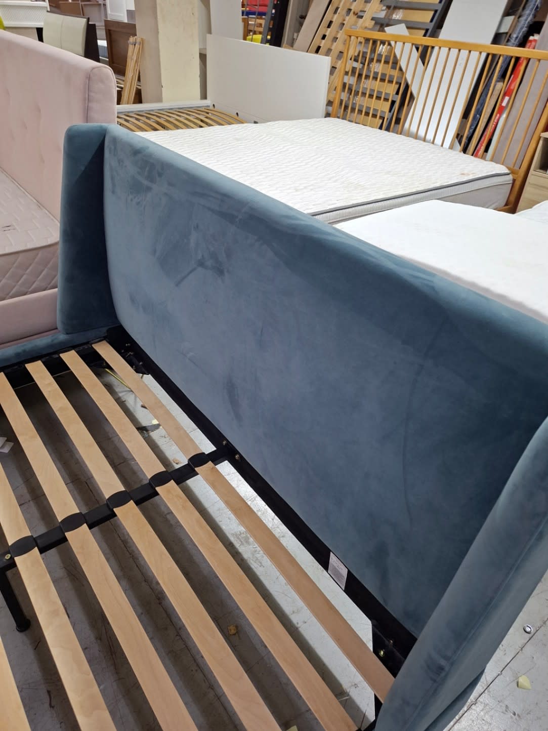 Close-up of teal velvet headboard showing light surface scuffs on used bed frame at Bufaisal Ajman
