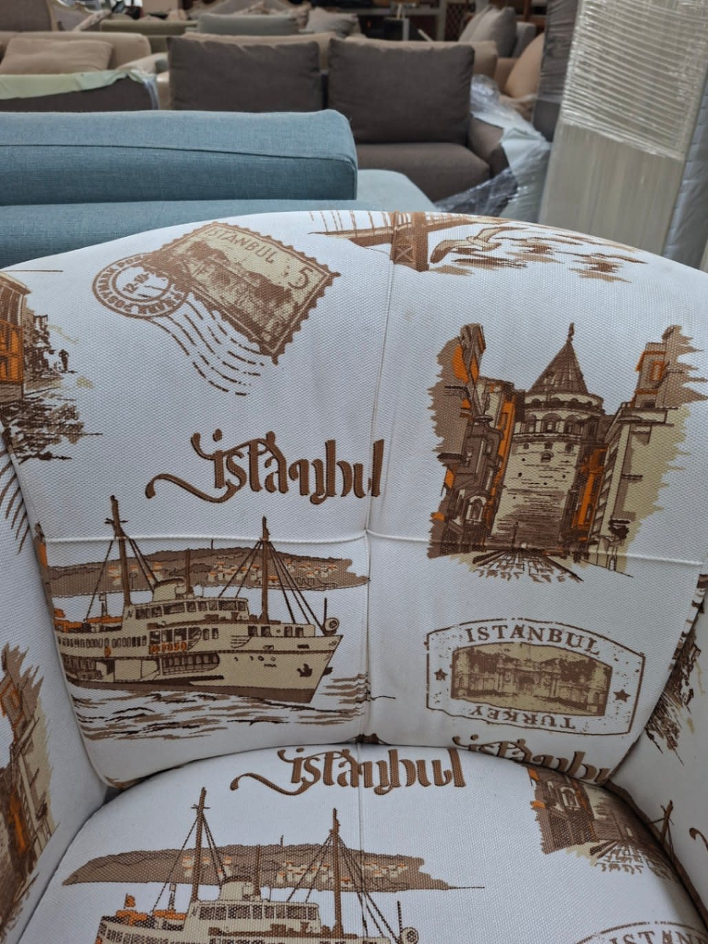 Close-up of Istanbul-print upholstery fabric on used tub accent chair at Bufaisal Ajman
