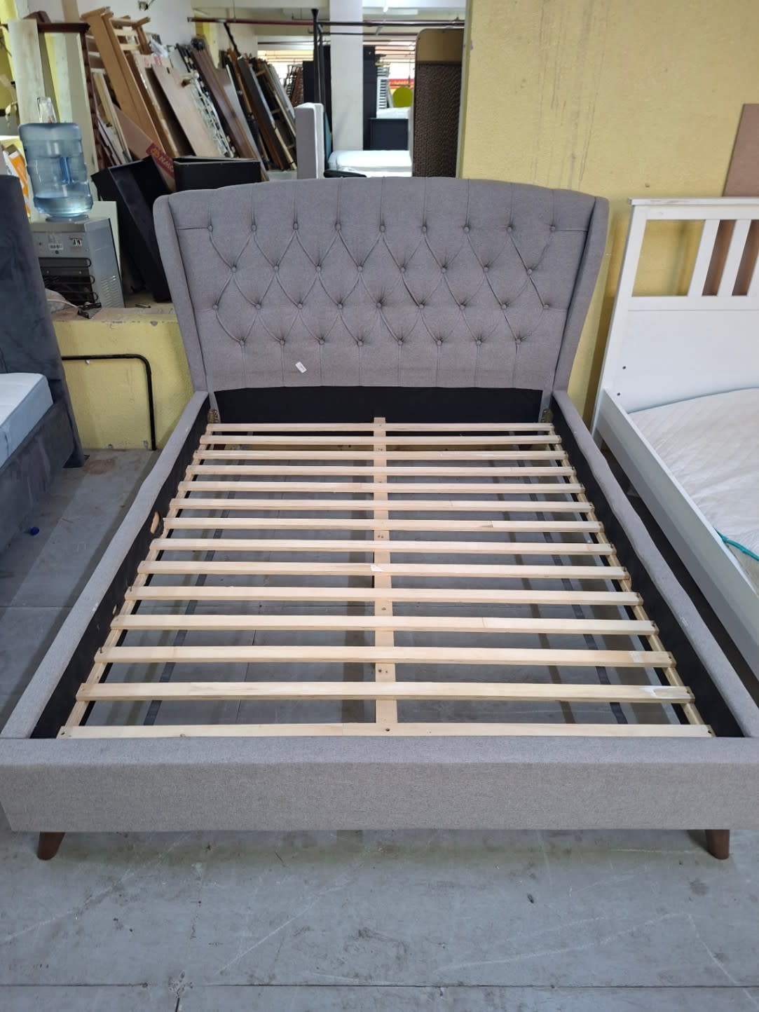 upholstered platform bed frame with a tufted headboard