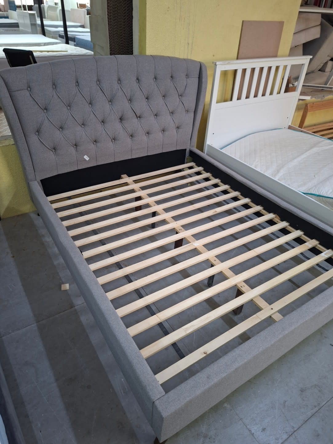 upholstered platform bed frame with a tufted headboard 2
