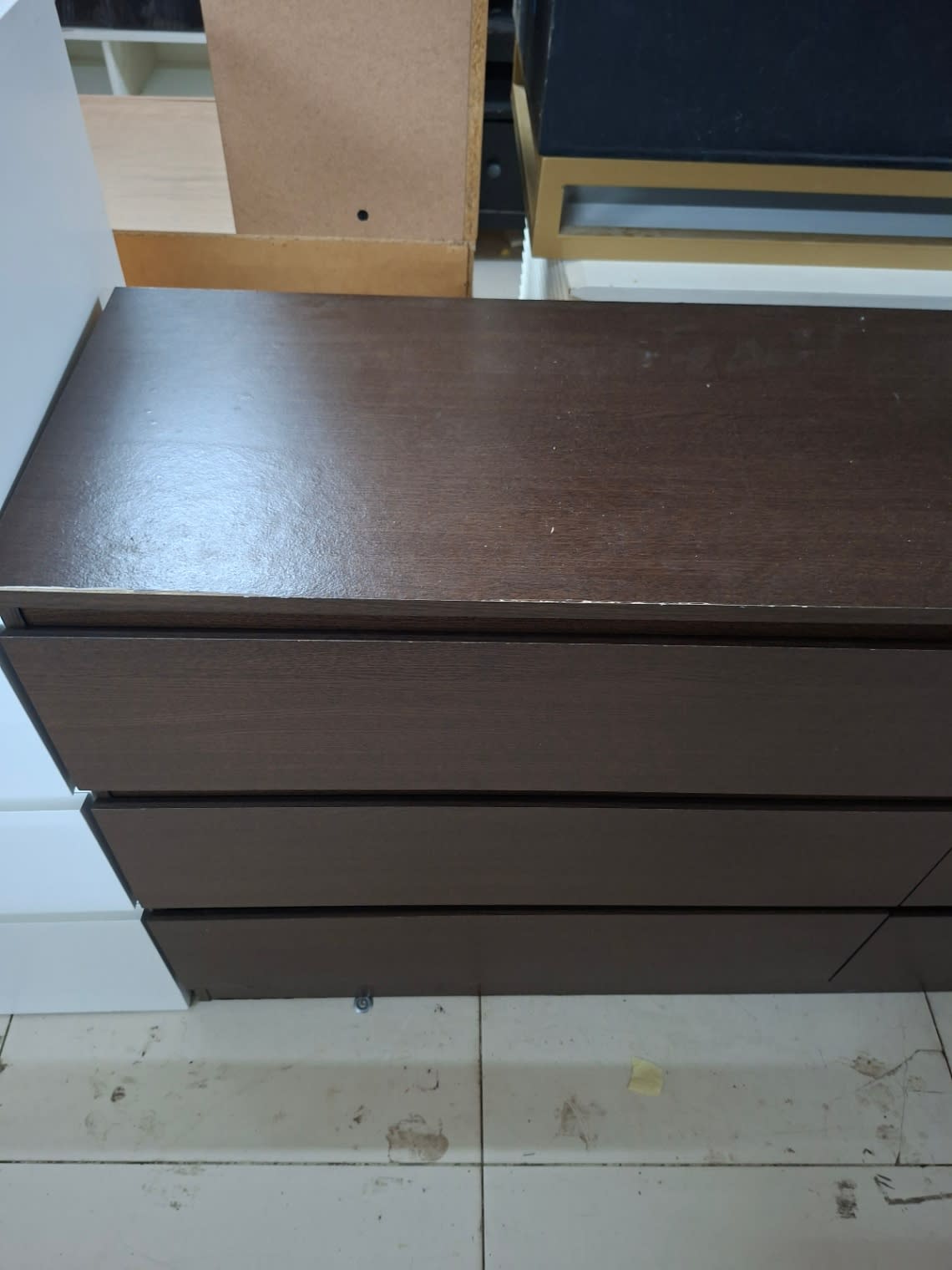Top corner detail of used 6-drawer double dresser showing minor edge chipping at Shop C Ajman