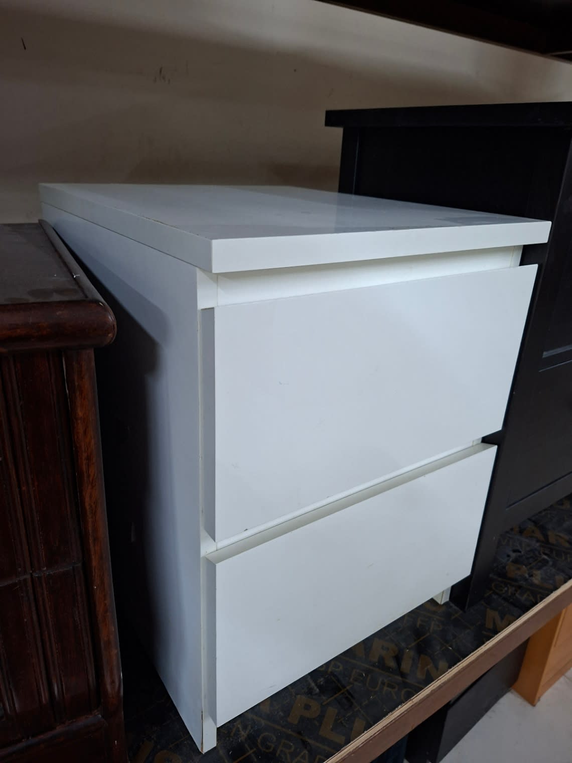 Side angle of used white 2-drawer bedside table nightstand at Shop C Ajman