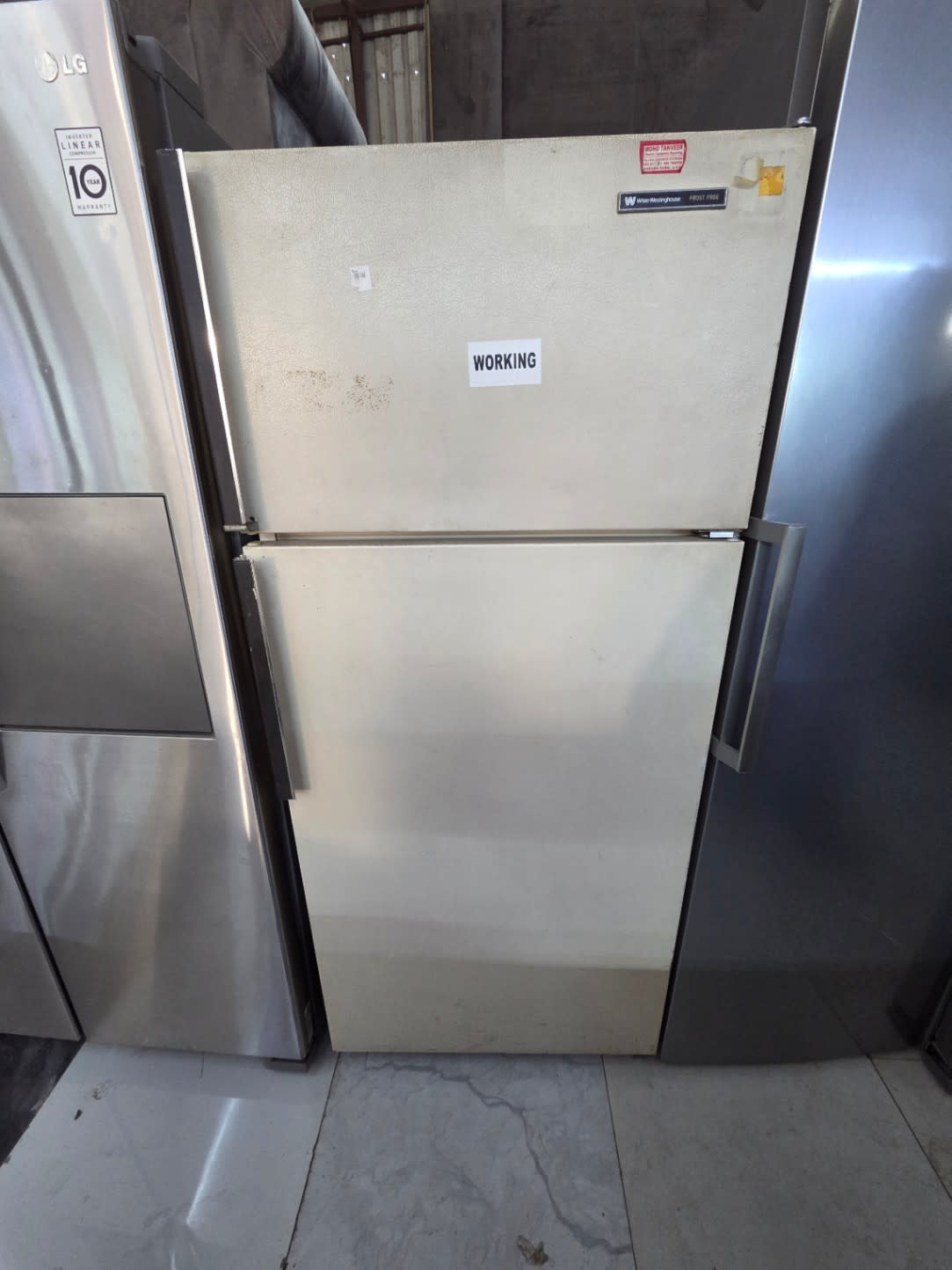 Front view of used White Westinghouse frost-free top-mount refrigerator at Bufaisal Shop D Ajman