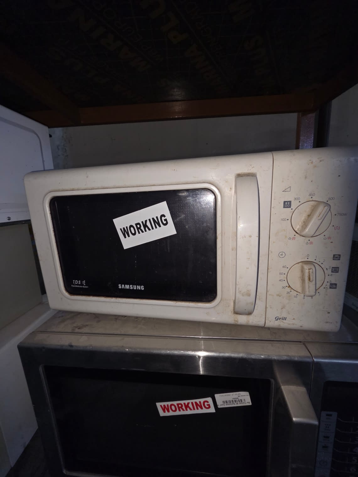 Bufaisal barcode label on used Samsung grill microwave oven at Shop D Ajman