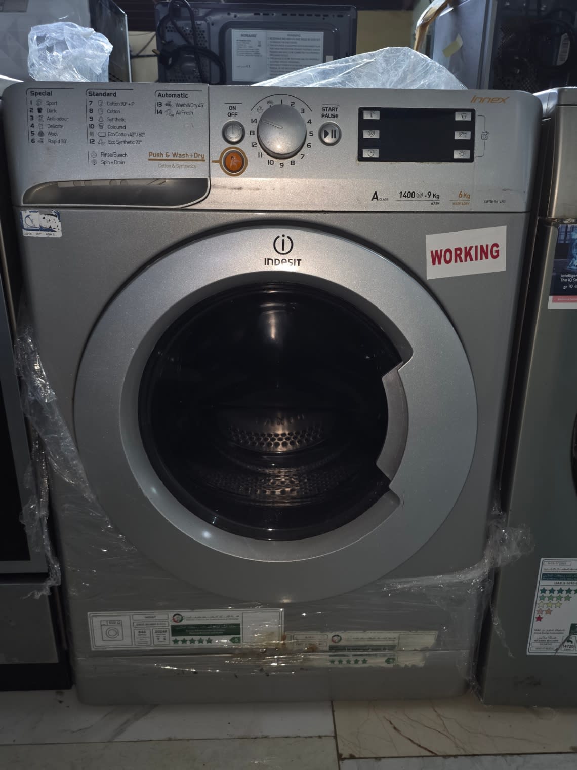 Front view of used Indesit Innex washer-dryer at Bufaisal Ajman with working sticker visible