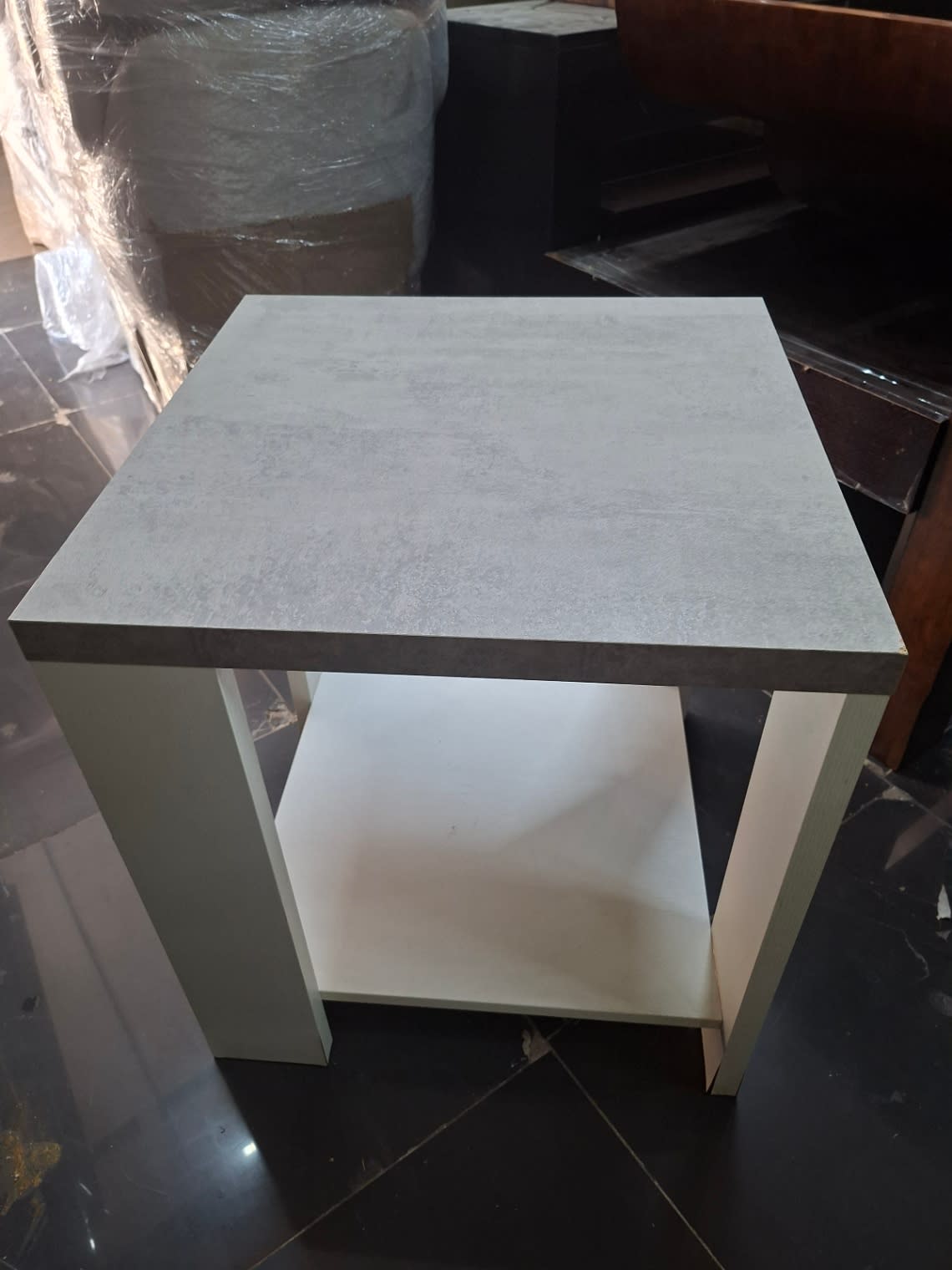 Top-down view of used white side table showing grey concrete-look top surface at Bufaisal Ajman