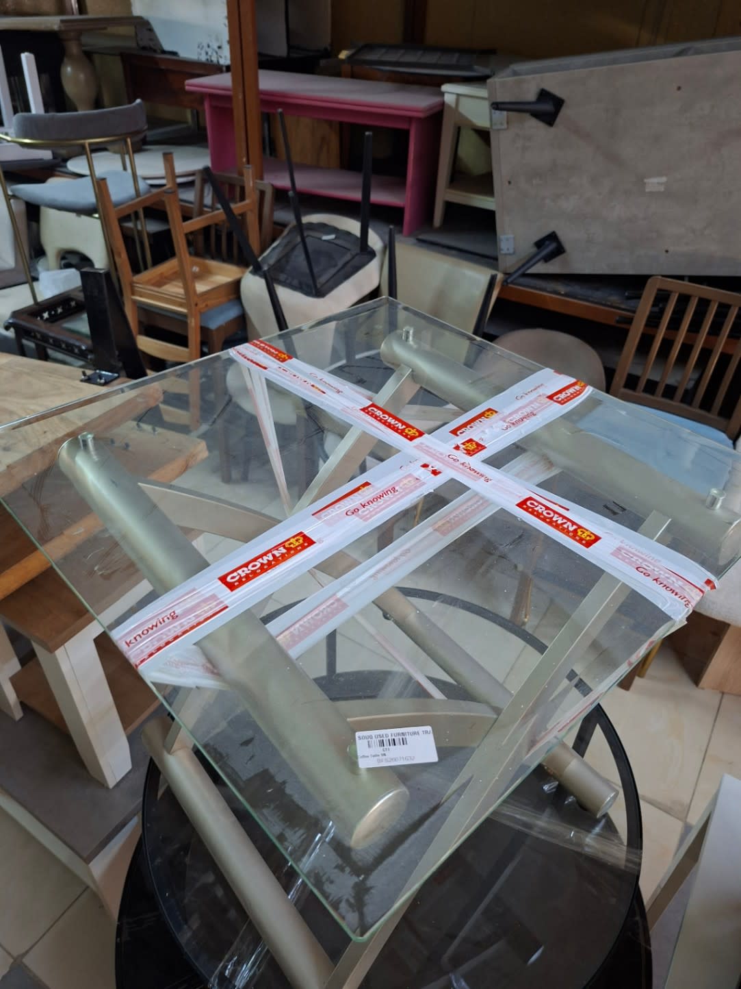 Bufaisal barcode label BFC26071032 for used glass-top coffee table at Shop C Ajman