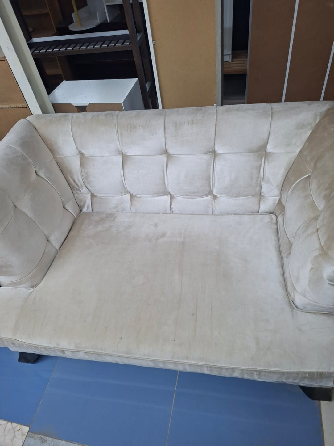 Additional angle of used 2-seater beige velvet sofa showing seat and fabric condition