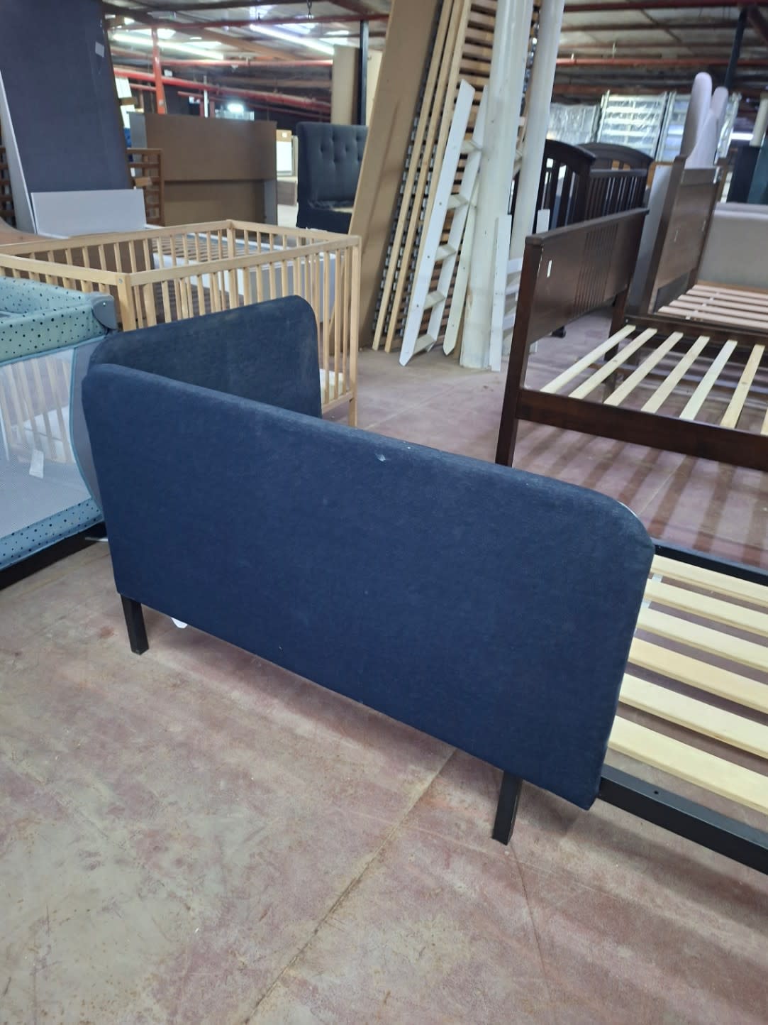 Back view of navy blue upholstered headboard on used single bed frame at Bufaisal Ajman