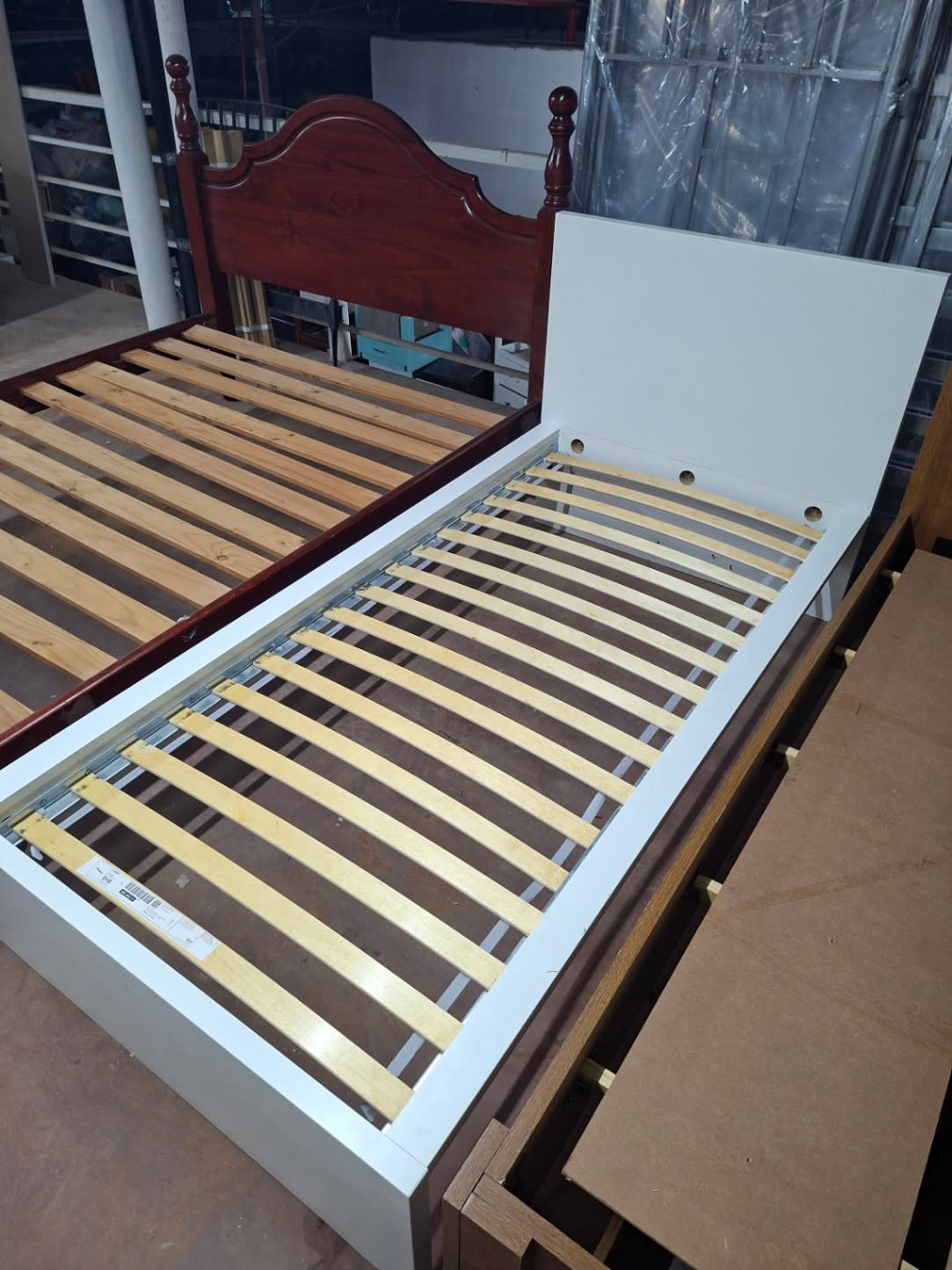 Full view of used white single bed frame from foot end showing slats and headboard at Bufaisal Ajman