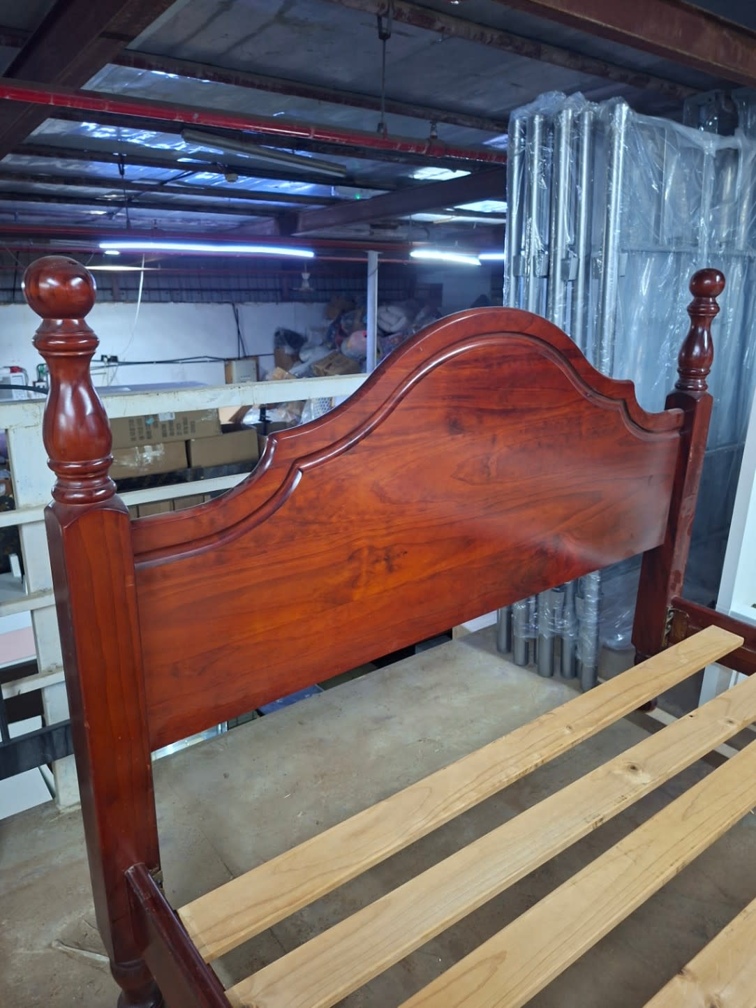 Close-up of headboard on used wooden four-poster bed frame in dark cherry finish at Bufaisal Shop D