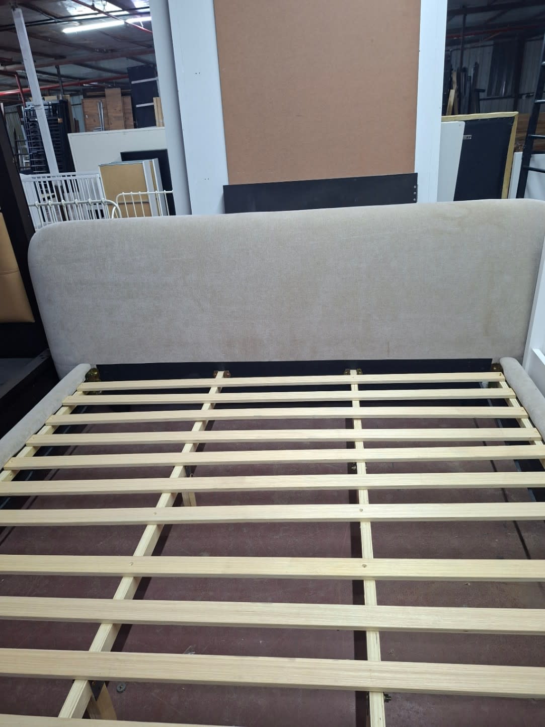 Front headboard view of used beige fabric queen bed frame at Bufaisal Shop D Ajman