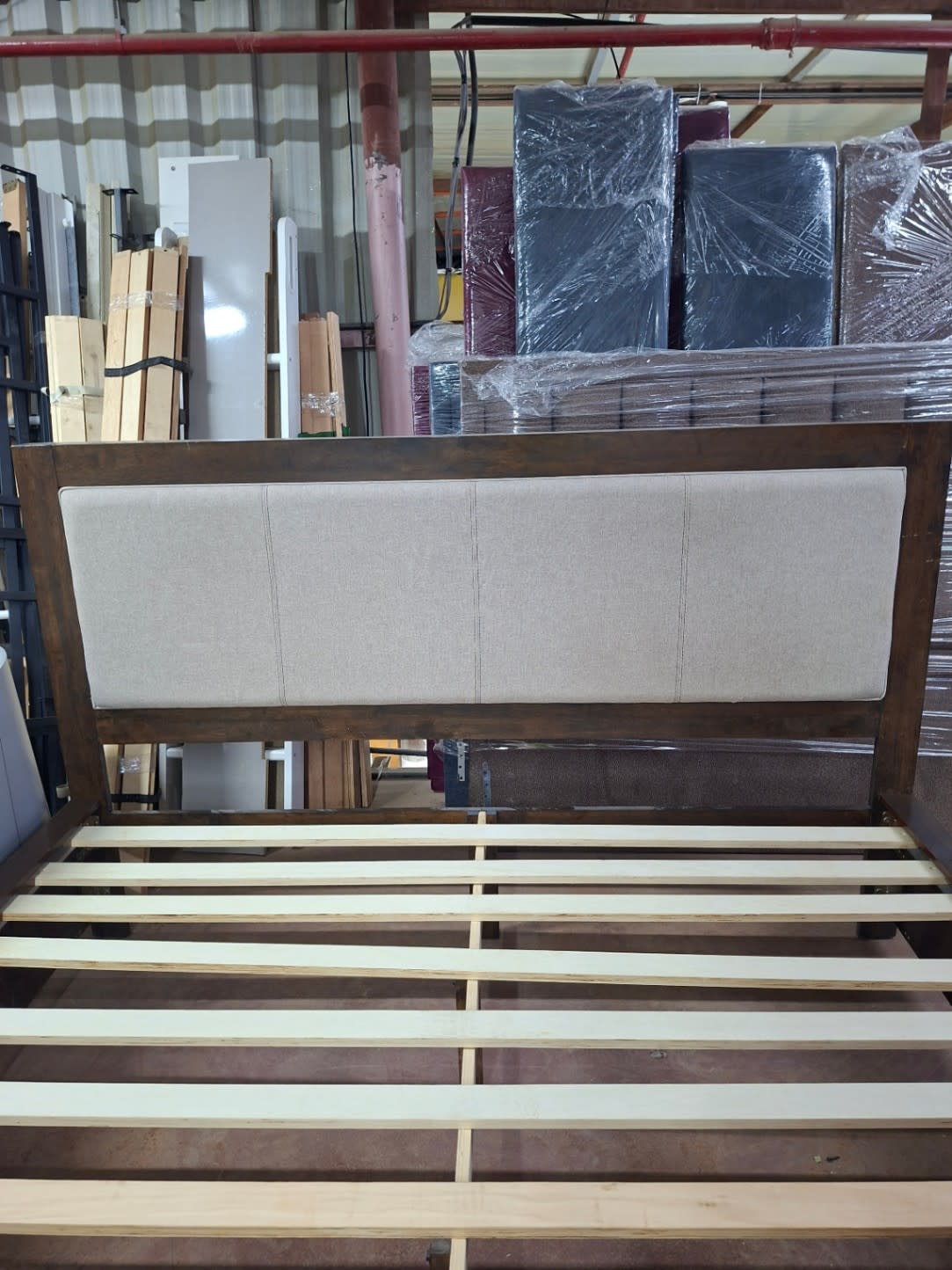 Front view of beige panel-stitched headboard on used king bed frame at Bufaisal Shop D Ajman