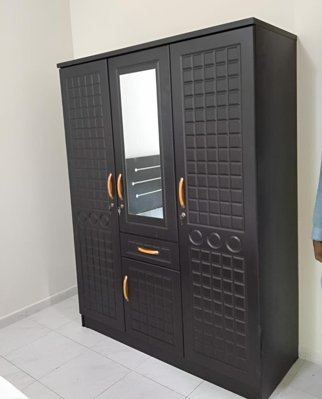 New 3-door wardrobe matte black angle view showing mirror drawer and keyed locks at Bufaisal Ajman