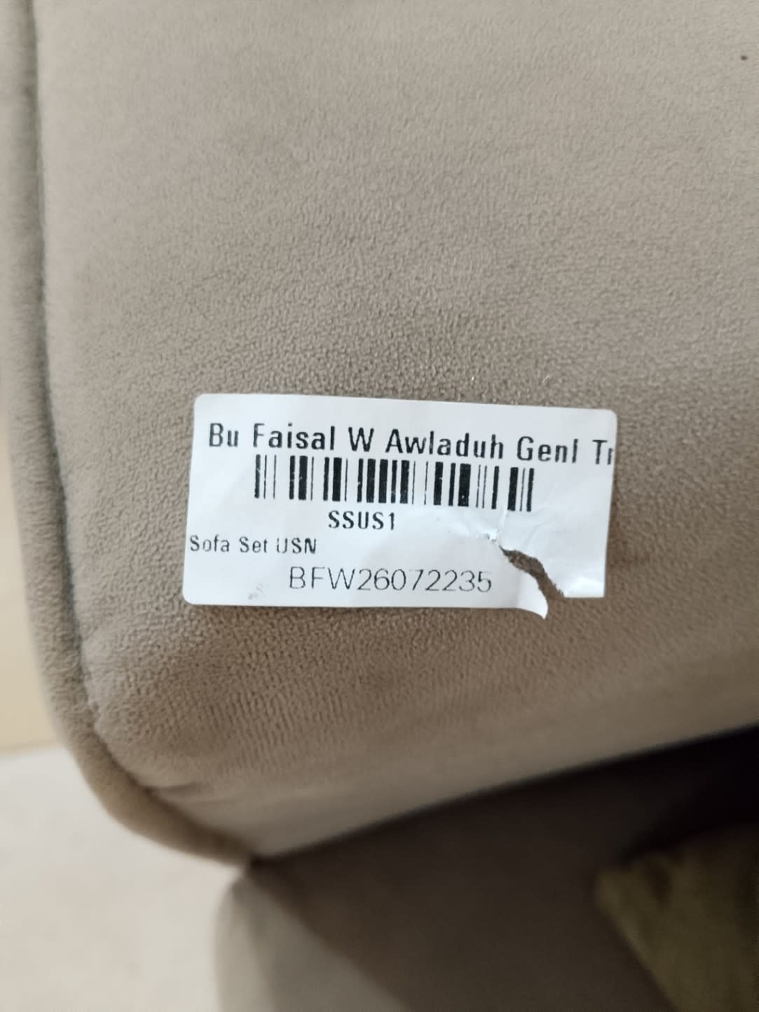 Bufaisal barcode label BFW26072235 for used L-shape sectional sofa at Shop D Ajman
