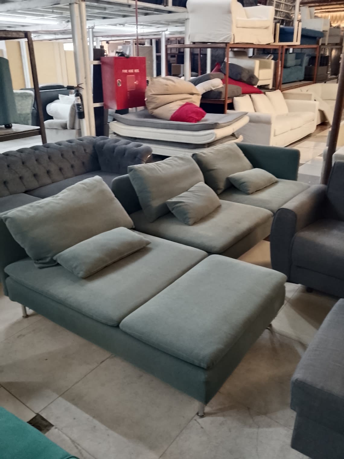 Full view of used sage green L-shape sectional sofa with metal legs at Bufaisal Shop D Ajman