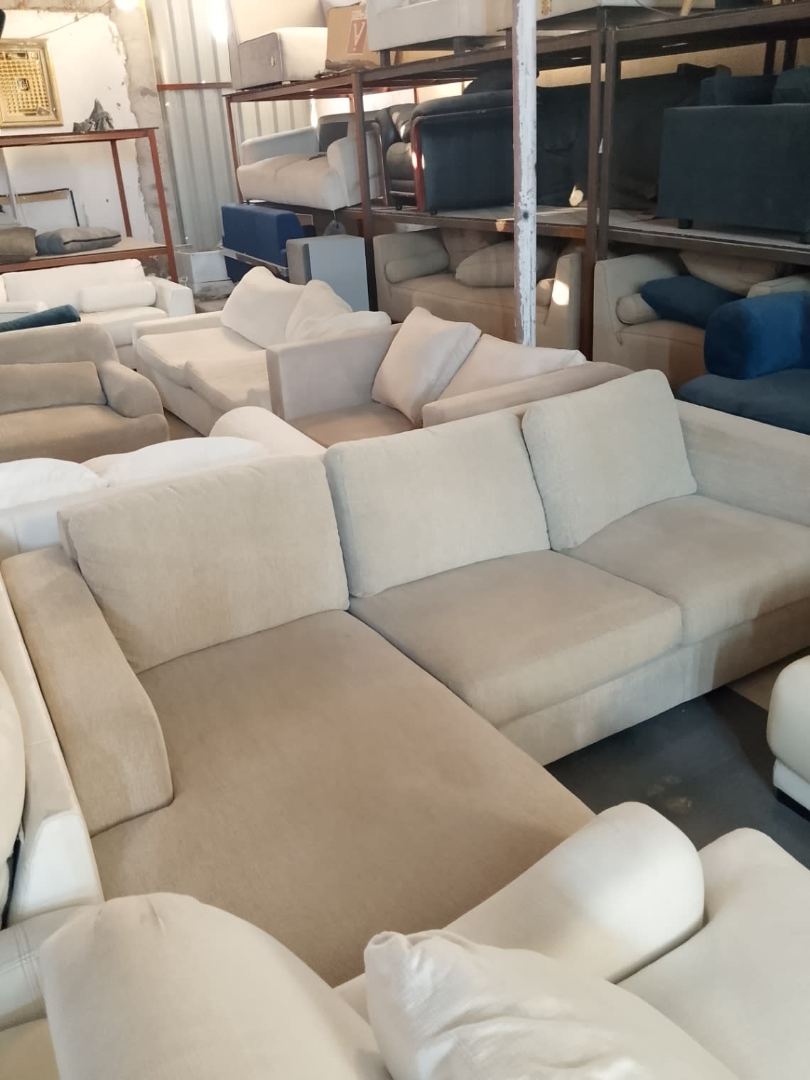 Bufaisal warehouse view of used beige L-shape sectional sofa available at Shop D Ajman