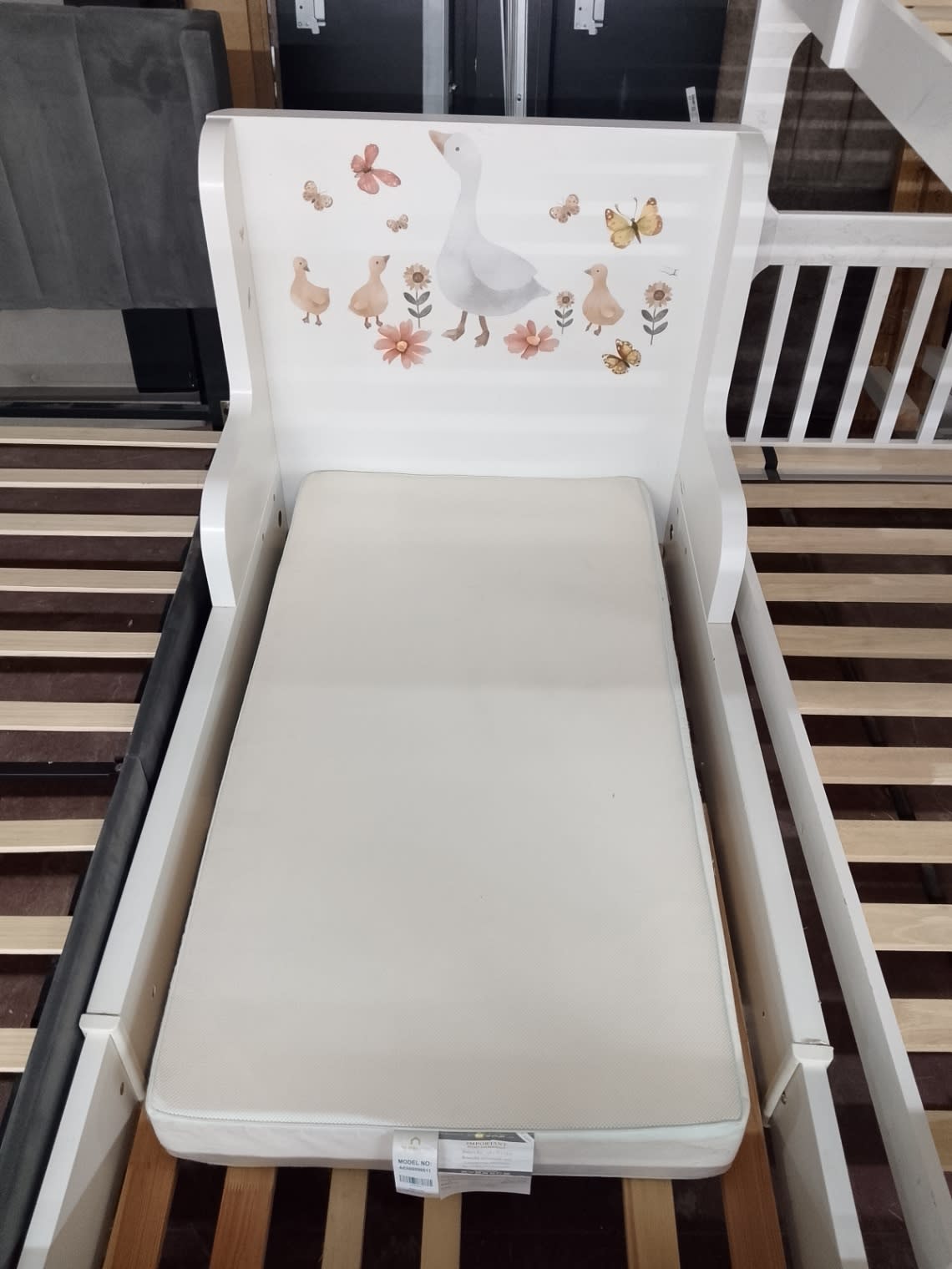 Mattress label tag on used white toddler bed with mattress at Bufaisal Shop D Ajman