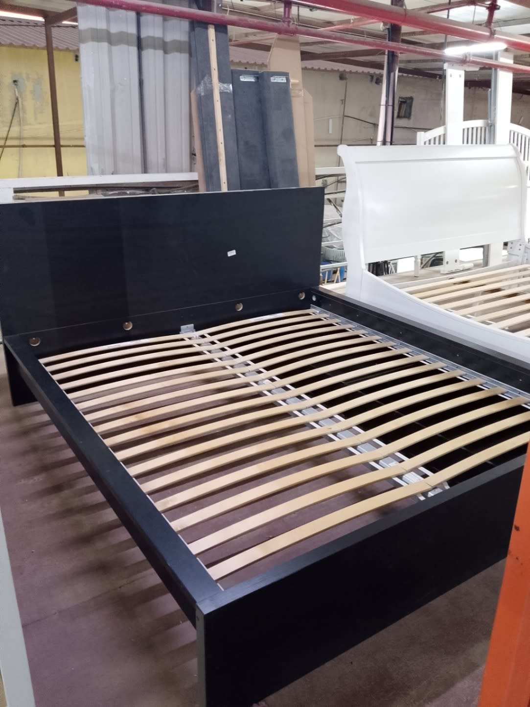 Second angle view of used queen bed frame black slatted base at Shop D Ajman Bufaisal