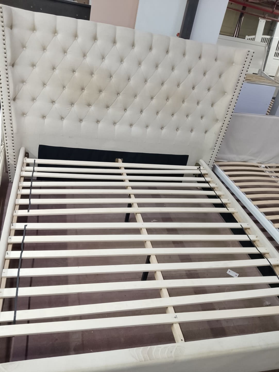 Bufaisal barcode label for used king wingback upholstered bed frame cream at Shop D Ajman