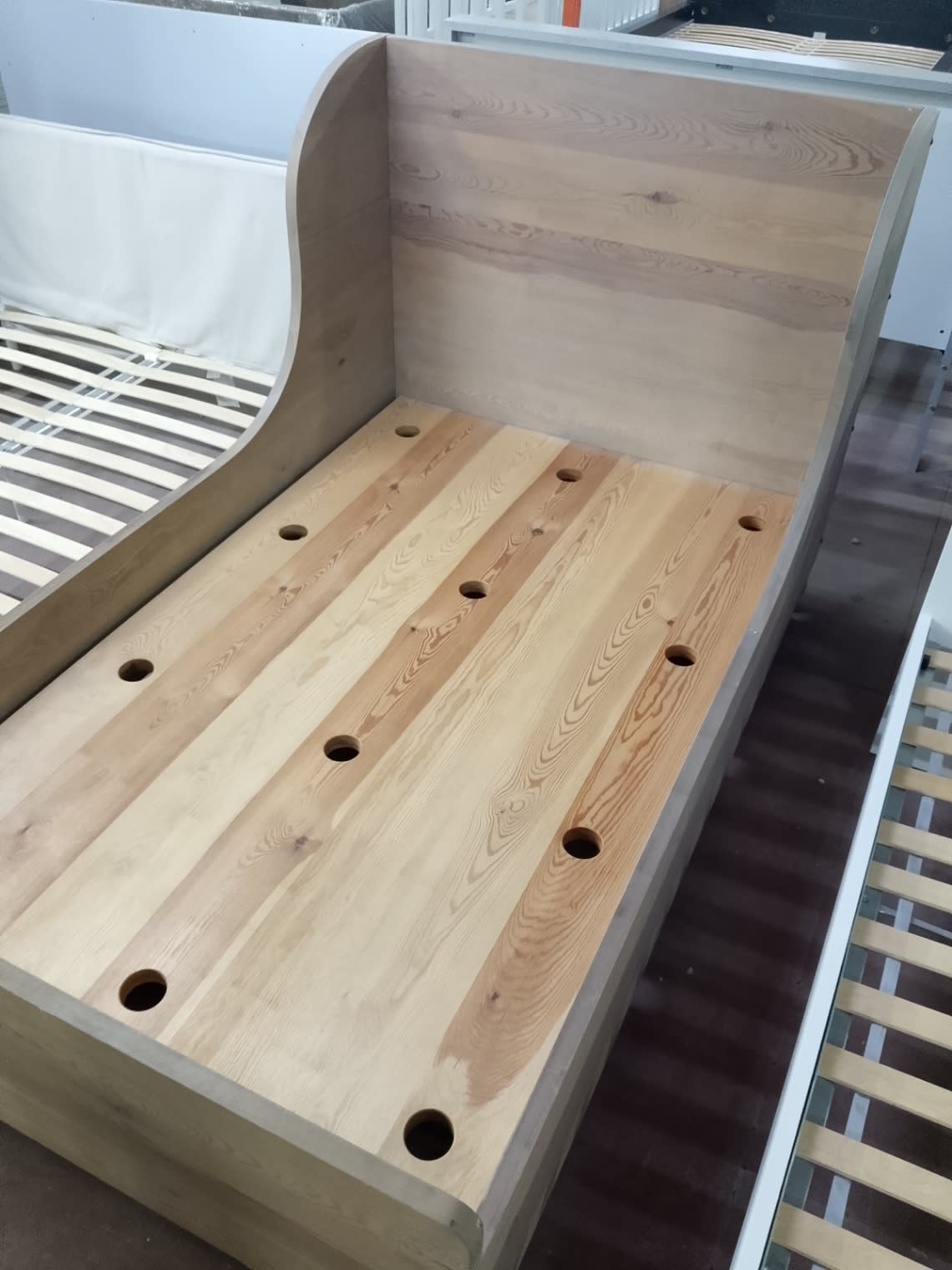 Detail view of solid wood panel base on used single sleigh bed frame at Bufaisal Ajman