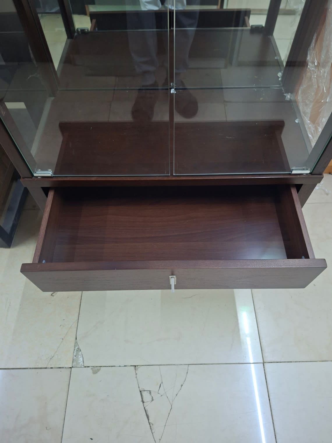 Open drawer detail of used glass display cabinet showing clean interior in good condition
