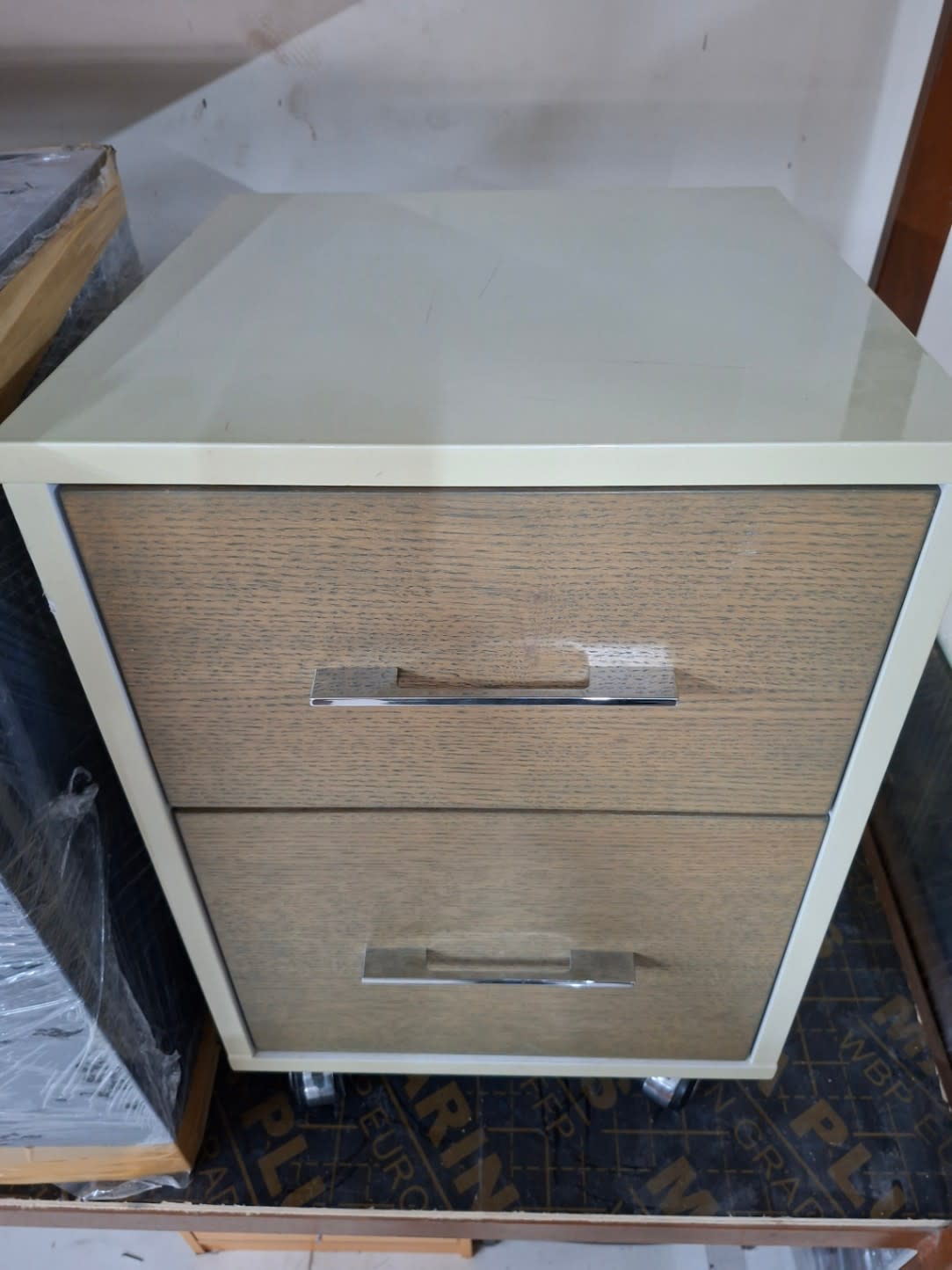 Angled top view of used 2-drawer pedestal cabinet on castors showing glass top surface, Bufaisal Shop C Ajman