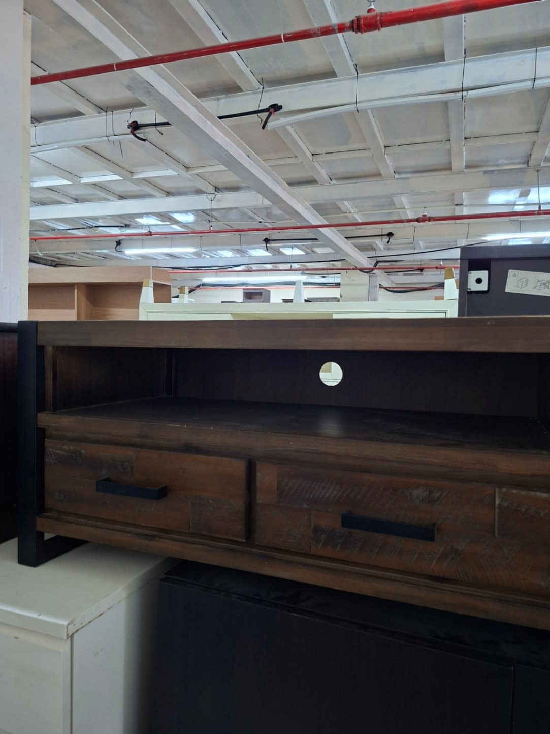 Side view of used wood TV stand with open shelf and cable management hole at Shop C Ajman