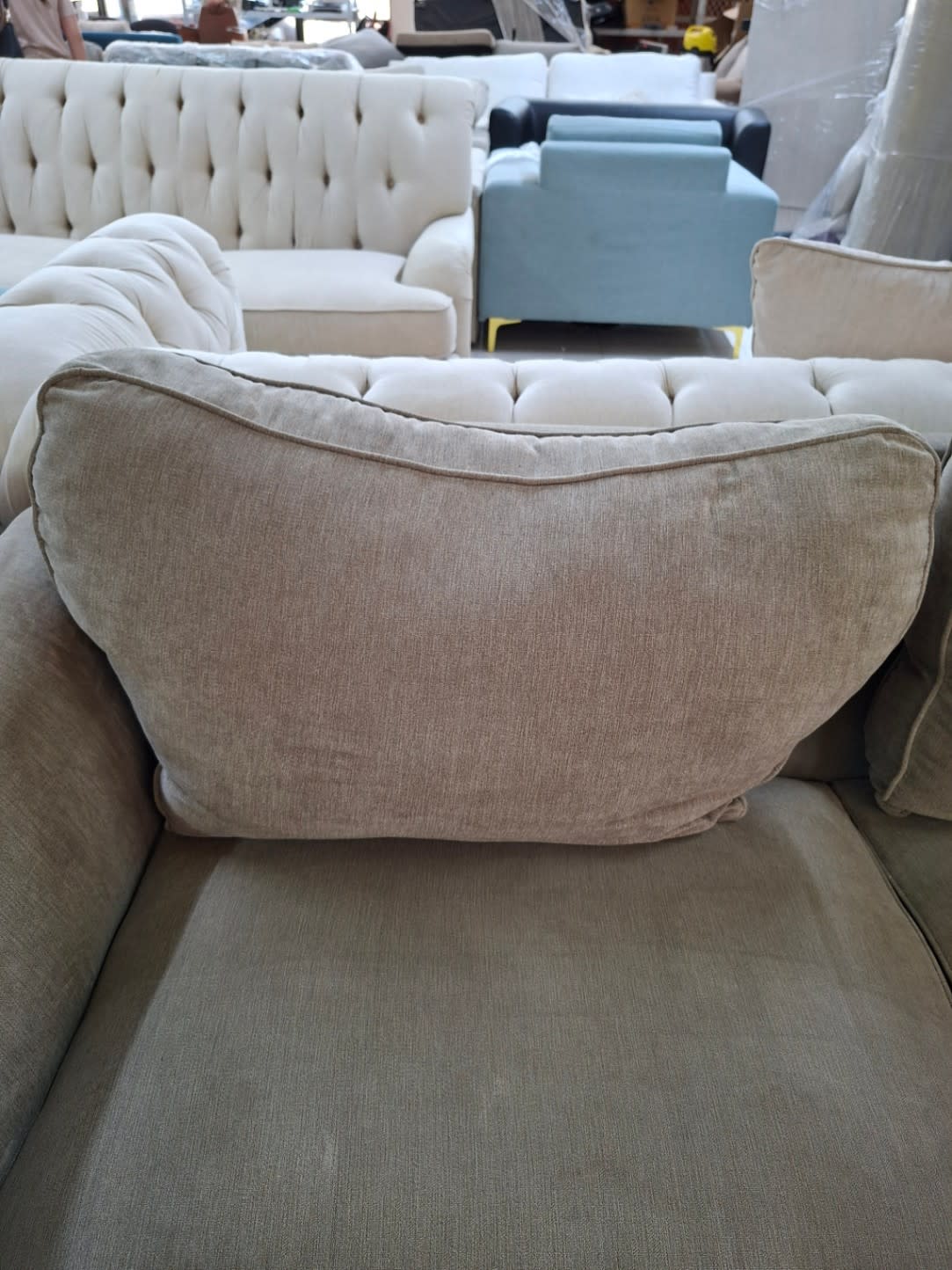 Detail of back cushion on used 2-seater beige sofa at Bufaisal Ajman