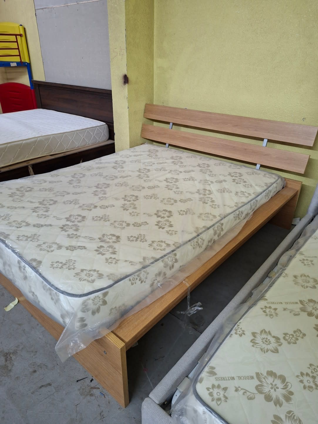 Used queen bed frame with mattress displayed in Bufaisal showroom Ajman