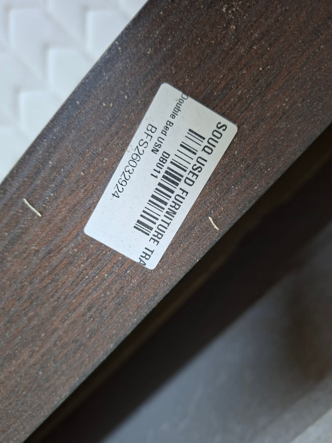 Bufaisal barcode label BFS26032392A for used double bed frame with storage at Shop C Ajman